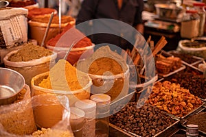 Assorted colorful, mixed spices selling at Goa trading. Salesman sell different grounded flavorings on commerce.