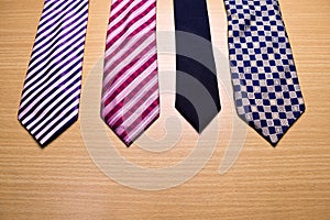 Assorted colorful Necktie on Wood Background
