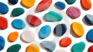 Assorted colorful pebble candies on white background.