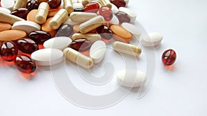 Assorted colorful pharmaceutical medicine pills, tablets and capsules on white background