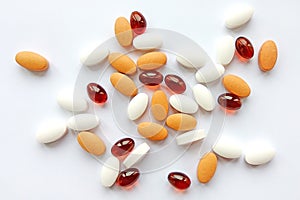 Assorted colorful pharmaceutical medicine pills, tablets and capsules on white background. Pharmacy theme, health care