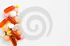 Assorted colorful tablets, pills, drugs on white background. Medication and healthcare concept