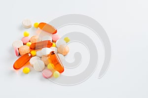 Assorted colorful tablets, pills, drugs on white background. Medication and healthcare concept