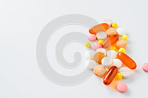 Assorted colorful tablets, pills, drugs on white background. Medication and healthcare concept