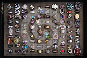 Assorted colorful vintage rings on a flea market stall