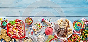 Assorted colourful party sweets with copy space