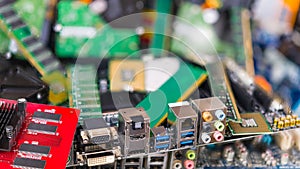 Assorted connectors on a computer mainboard detail in an e-waste pile