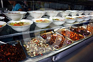 Assorted cooked food on display at a neighborhood eatery photo