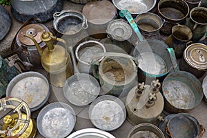Assorted copperware and rugs on flea market