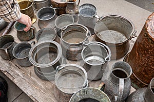 Assorted copperware and rugs on flea market