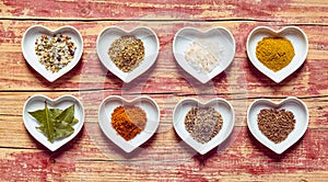 Assorted culinary spices in heart shaped dishes