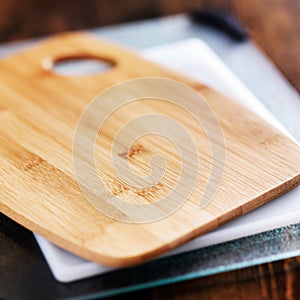 Assorted cutting boards in a pile photo