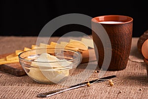 Assorted dairy products milk, cheese, butter rustic still life on table