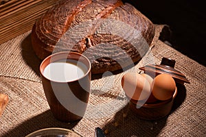 Assorted dairy products milk, cheese, eggs. rustic still life on table