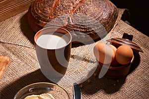 Assorted dairy products milk, cheese, eggs. rustic still life on table