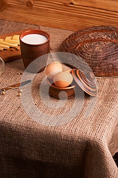 Assorted dairy products milk, cheese, eggs. rustic still life on table