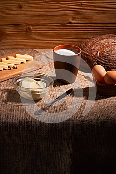 Assorted dairy products milk, cheese, eggs. rustic still life on table