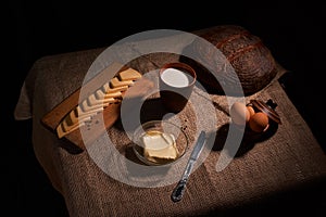 Assorted dairy products milk, cheese, eggs. rustic still life on table