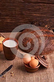 Assorted dairy products milk, cheese, eggs. rustic still life on table