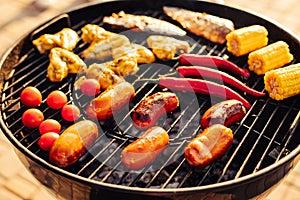 Assorted delicious grilled meat with grilled vegetables, barbecue with smoke and flame