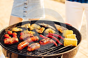 Assorted delicious grilled meat with grilled vegetables, barbecue with smoke and flame