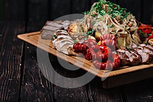 Assorted delicious grilled meat, sausages and vegetables on cutt