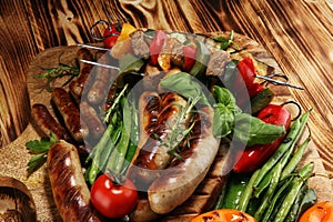 Assorted delicious grilled meat with vegetable on a barbecue. Grilled pork shish or kebab on skewers with vegetables . Food