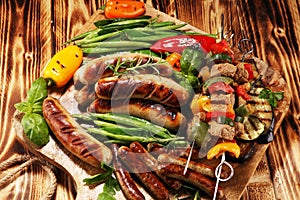 Assorted delicious grilled meat with vegetable on a barbecue. Grilled pork shish or kebab on skewers with vegetables . Food