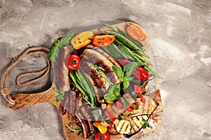 Assorted delicious grilled meat with vegetable on a barbecue. Grilled pork shish or kebab on skewers with vegetables . Food