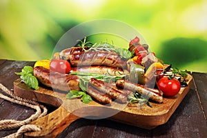 Assorted delicious grilled meat with vegetable on a barbecue. Grilled pork shish or kebab on skewers with vegetables . Food