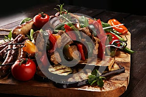 Assorted delicious grilled meat with vegetable on a barbecue. Grilled pork shish or kebab on skewers with vegetables . Food