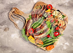 Assorted delicious grilled meat with vegetable on a barbecue. Grilled pork shish or kebab on skewers with vegetables . Food