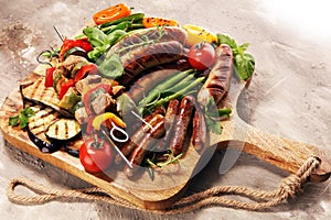 Assorted delicious grilled meat with vegetable on a barbecue. Grilled pork shish or kebab on skewers with vegetables . Food