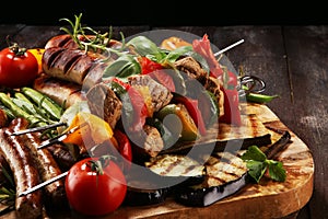 Assorted delicious grilled meat with vegetable on a barbecue. Grilled pork shish or kebab on skewers with vegetables . Food