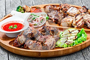 Assorted delicious grilled meat and vegetables with fresh salad