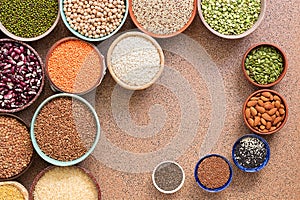 Assorted different of legumes, beans, grains and seeds in bowls. Top view, flat lay, copy space