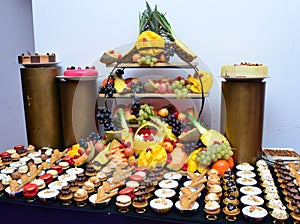 Assorted different mini cakes with cream, chocolate and berries-Sweets offered at the Moroccan wedding