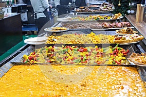 Assorted dishes of european street food, curry, ratatouille and grilled meats