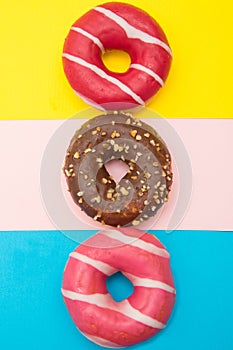 Assorted donuts with chocolate on light blue background