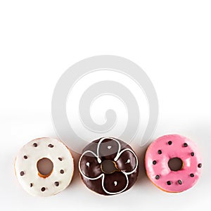 Assorted donuts with chocolate frosted and pink glazed isolated on white background, top view