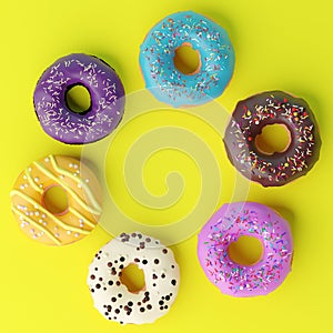 Assorted donuts with colorful icings on yellow background.