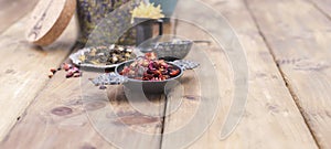 Assorted dried flowers and tea on a wooden background. Natural health. Aromatherapy. Free space for text. Copy space.