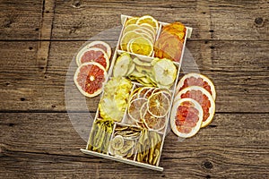 Assorted dried fruits. Healthy eating concept. Wooden box, old boards background