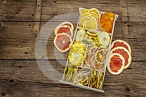 Assorted dried fruits. Healthy eating concept. Wooden box, old boards background