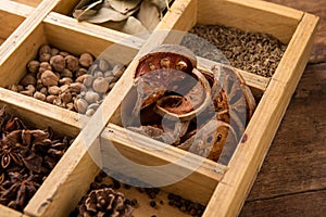 Assorted dried herbs in a printers tray with focus to chamomile