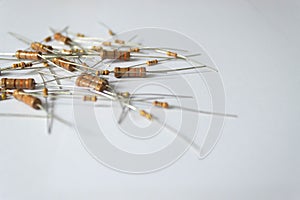 Assorted electronic resistors scattered on white background