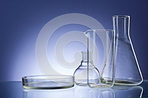 Assorted empty laboratory glassware, test-tubes. Green tone medical background. Copy space photo