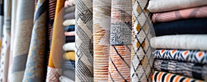 Assorted fabric rolls displayed in a textile shop