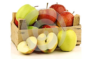 Assorted fresh apples in a wooden crate