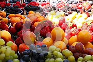 assorted fresh berries (berry) fruits in a street stall for sell